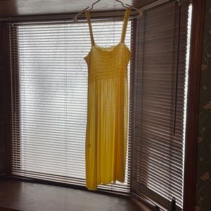 Lemon yellow sheer sundress, just below knees.